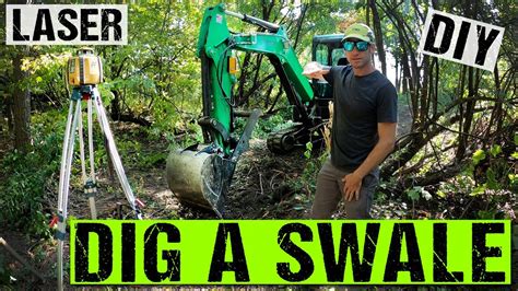 dig a swale with a mini excavator|digging swales in the wild.